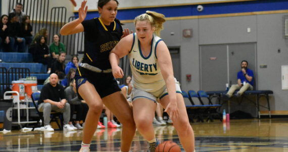 Ella Whitaker looks to go past a Wolverine defender. Ben Ray / The Reporter