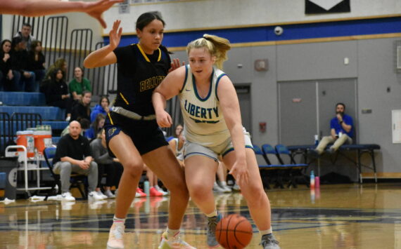 Ella Whitaker looks to go past a Wolverine defender. Ben Ray / The Reporter