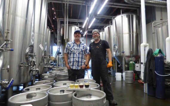 Danny Bohm (right) and Jesse Brown (left) stand over the four award-winning WBC beers in the manufactory portion of the brewery. (Cameron Sires/ Sound Publishing)