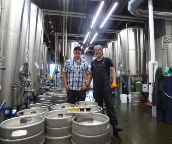 Danny Bohm (right) and Jesse Brown (left) stand over the four award-winning WBC beers in the manufactory portion of the brewery. (Cameron Sires/ Sound Publishing)