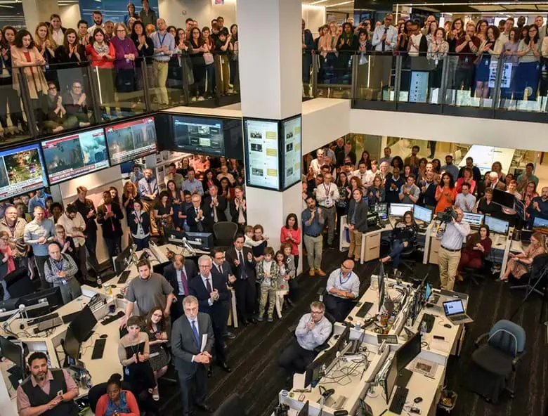 Reporters and editors watch news of the Pulitzer prizes in the newsroom of the Washington Post, in Washington, DC.