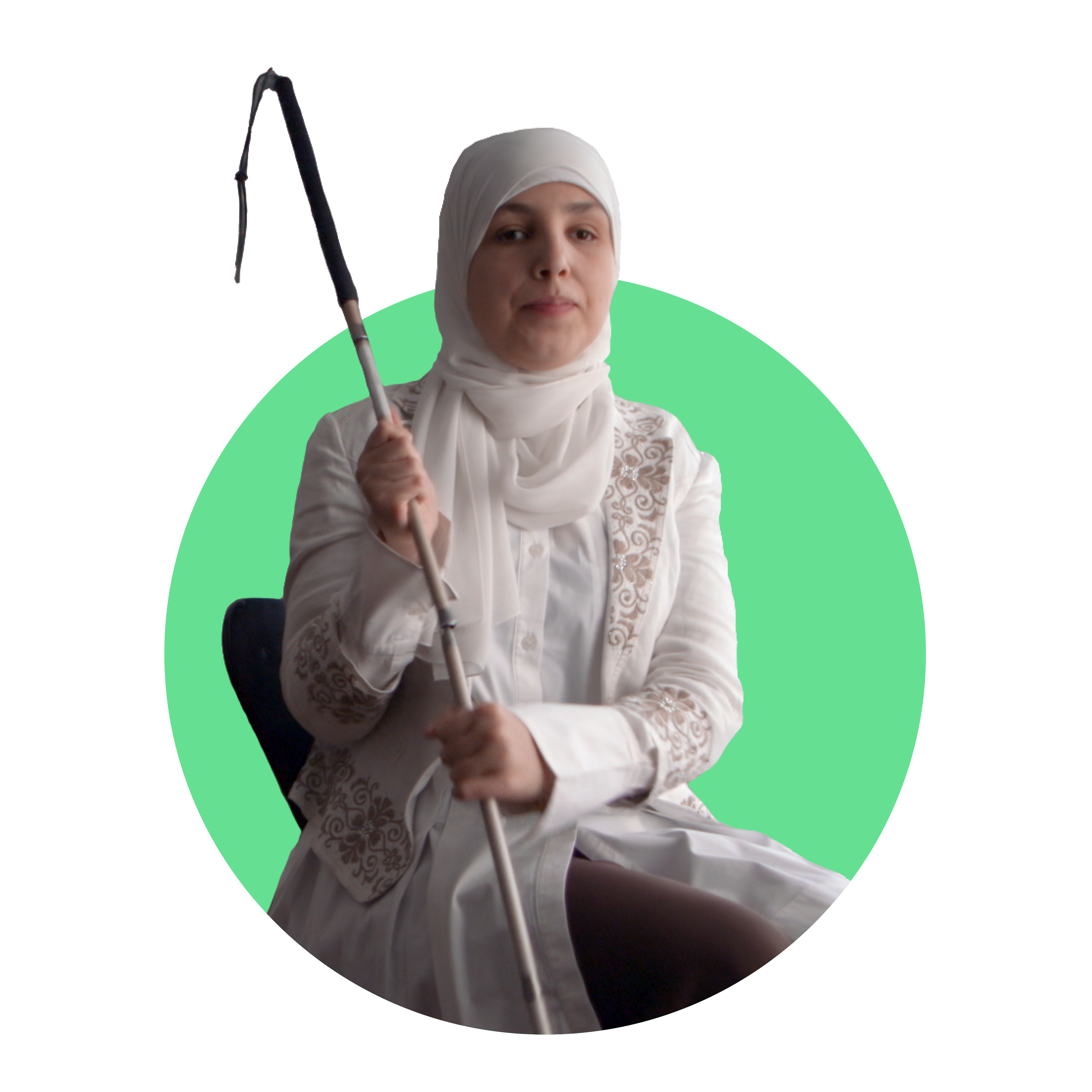 Sara Minkara, a blind Lebanese-American woman, wearing a white headscarf holds her cane with both hands to her right while seated.
